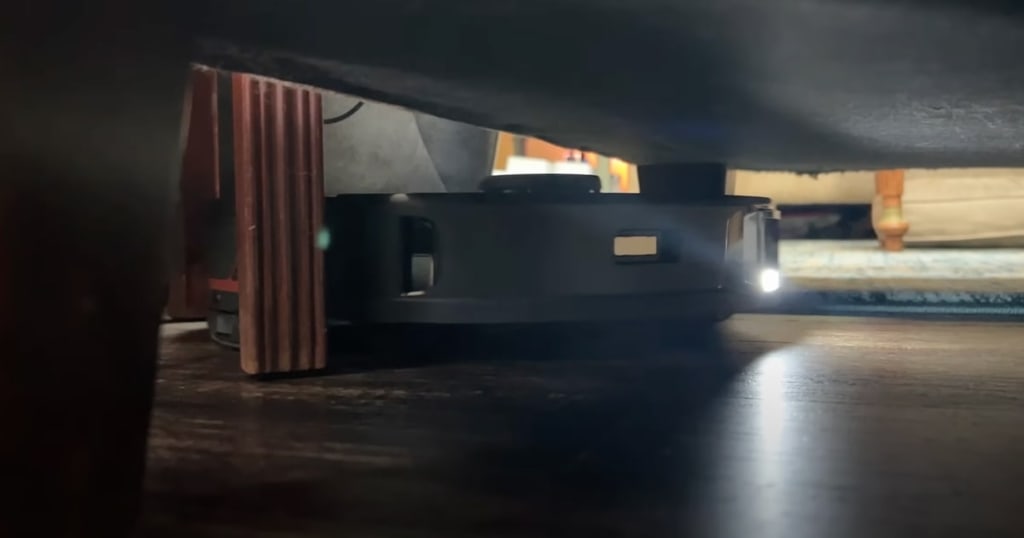 Roborock S7 MaxV Using its LED Headlight While Cleaning Under Furniture