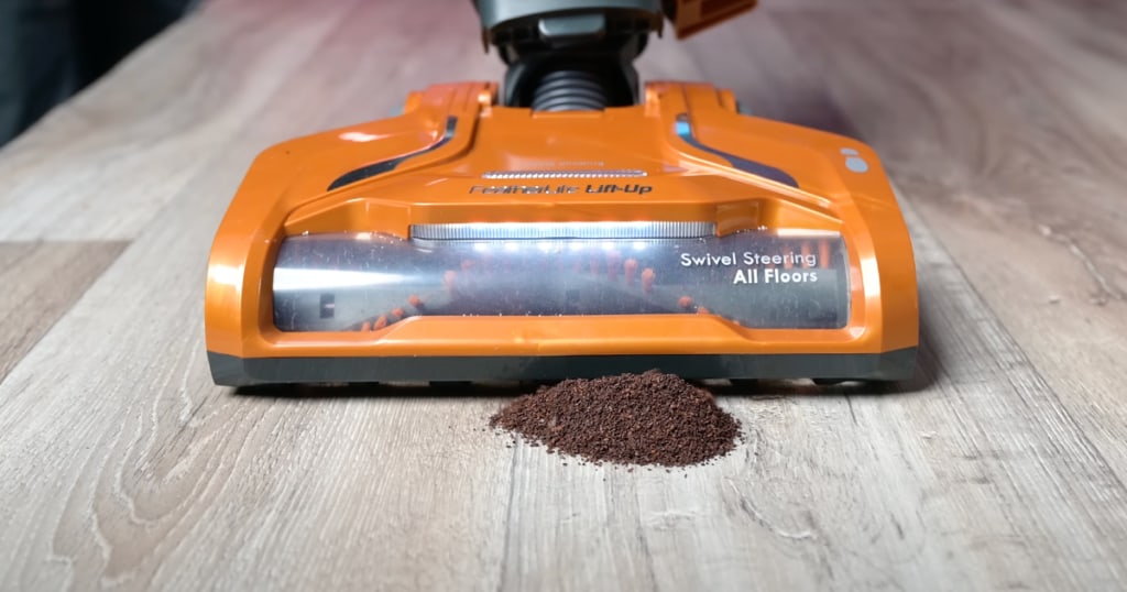 Vacuuming Coffee Grounds on Hard Flooring